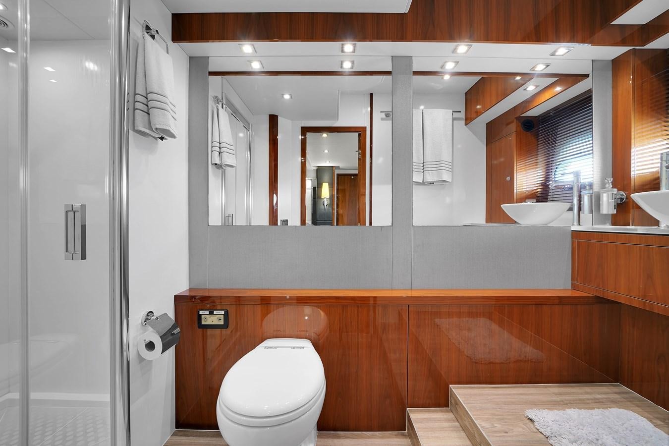 a bathroom with a toilet and a sink aboard SUNSEEKER 73 2013 Yacht for Sale