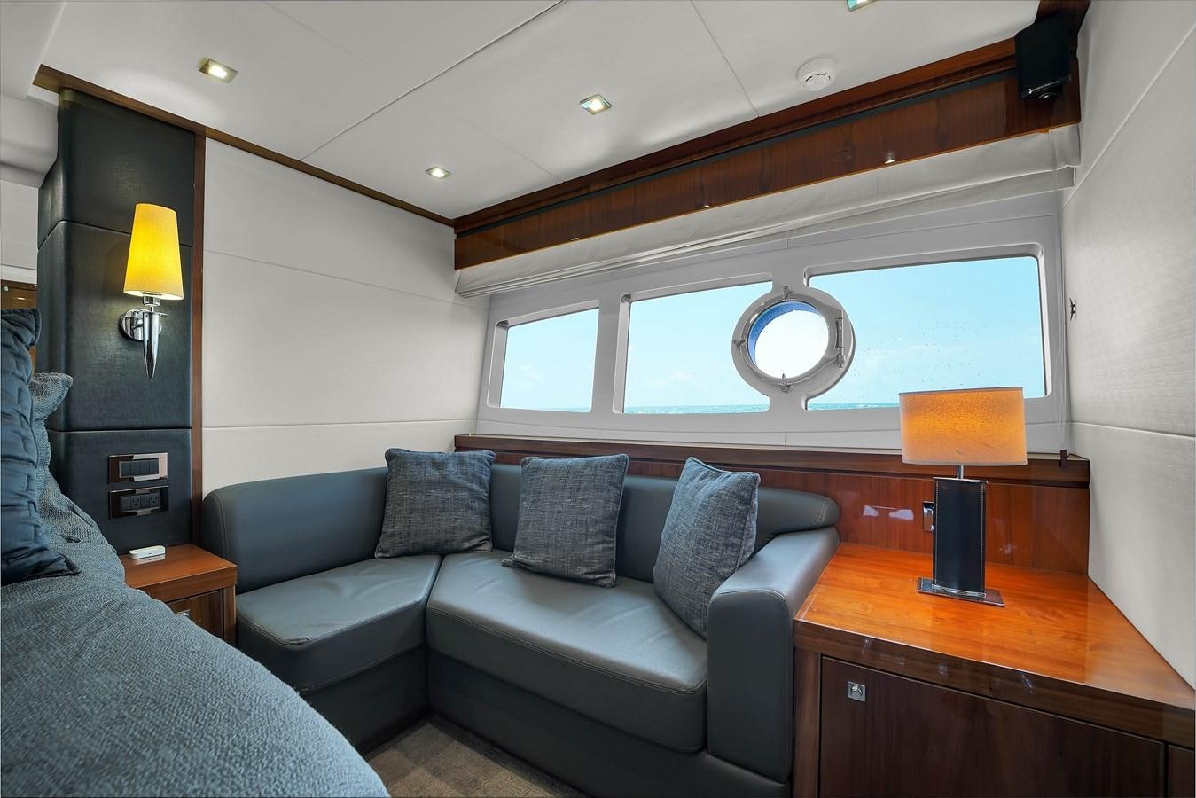 a living room with a couch and a tv aboard SUNSEEKER 73 2013 Yacht for Sale