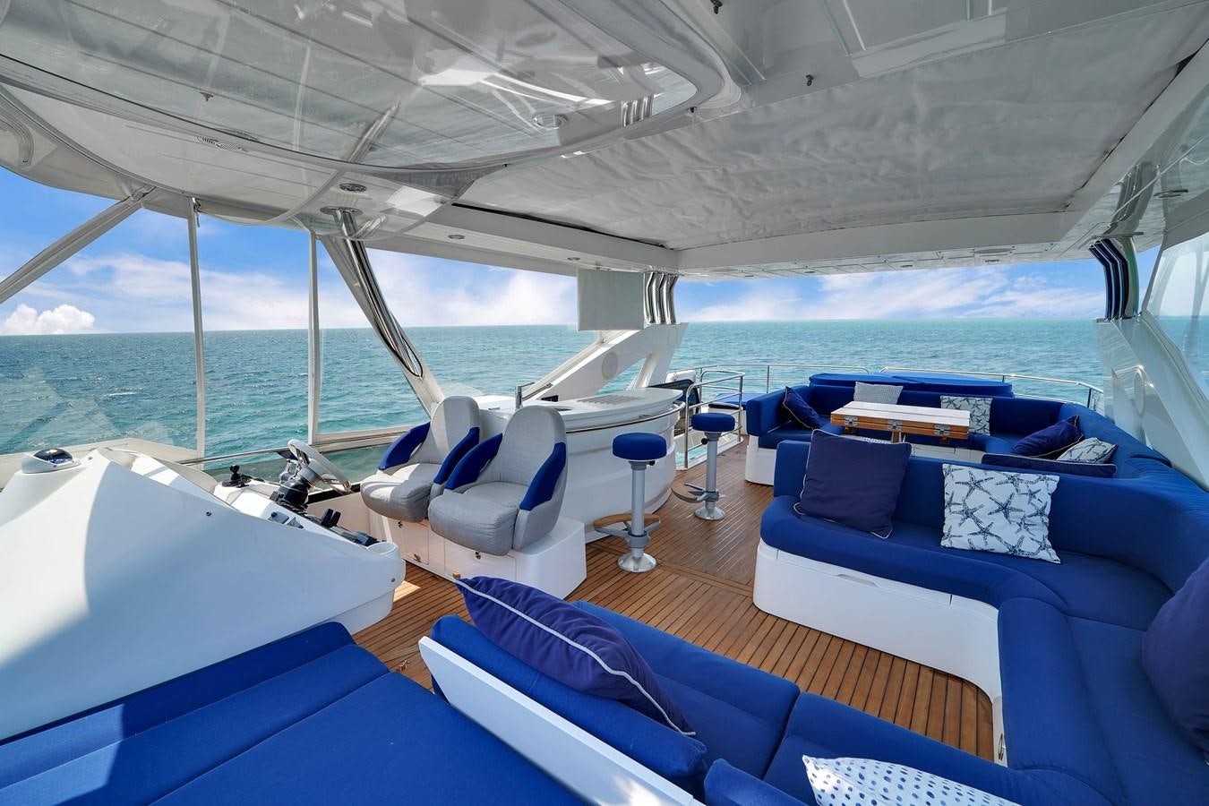a boat with a large blue body of water and a blue couch aboard SUNSEEKER 73 2013 Yacht for Sale