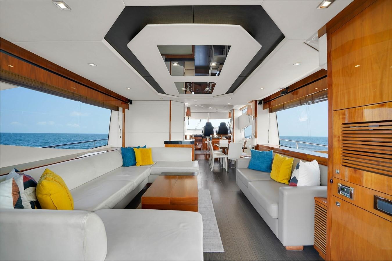 a room with a couch and a table and a window aboard SUNSEEKER 73 2013 Yacht for Sale