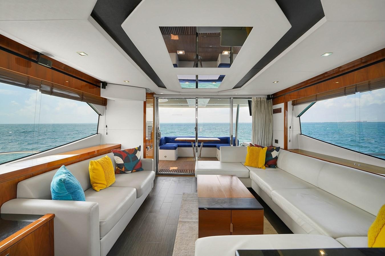 a living room with a large window aboard SUNSEEKER 73 2013 Yacht for Sale