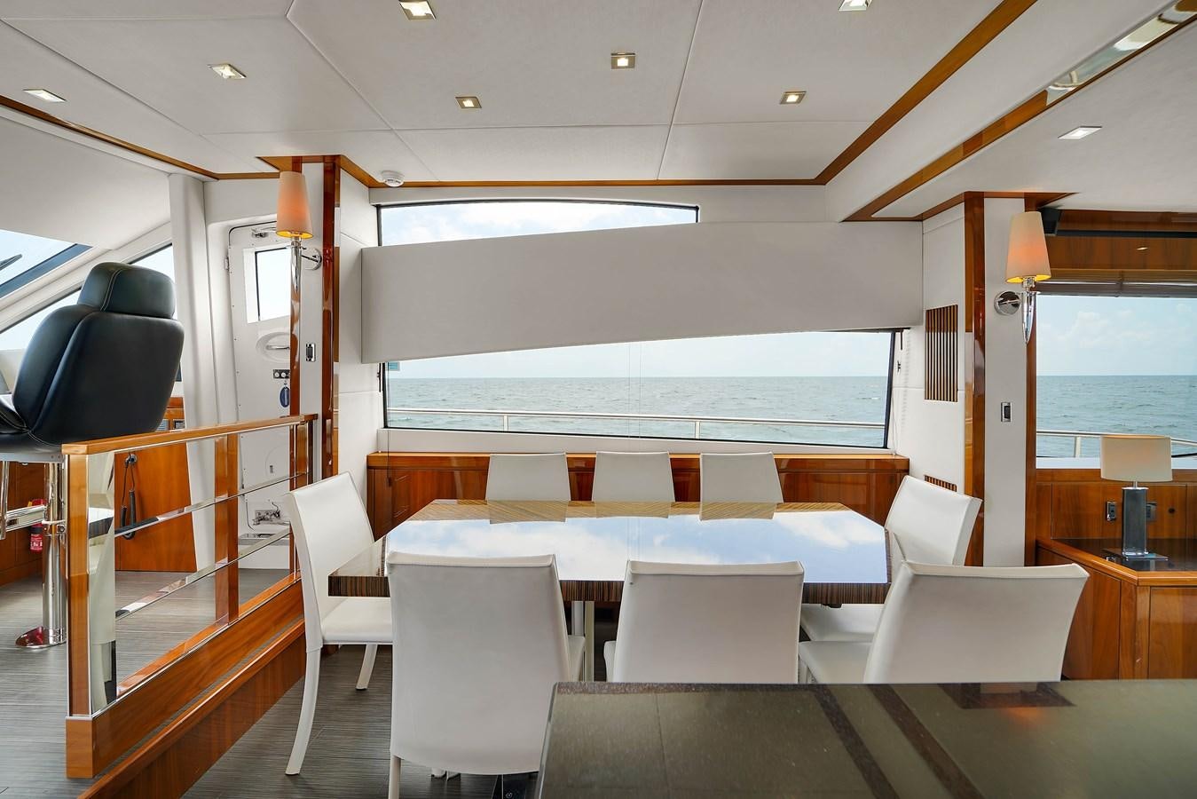 a room with tables and chairs aboard SUNSEEKER 73 2013 Yacht for Sale