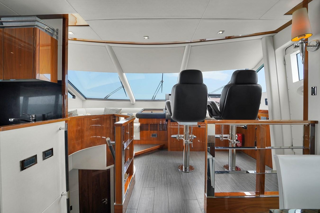 a room with a desk and chairs aboard SUNSEEKER 73 2013 Yacht for Sale