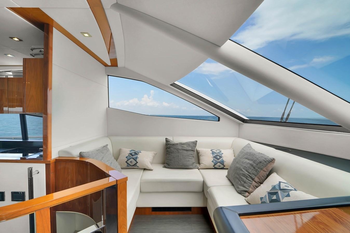 a room with a couch and a window aboard SUNSEEKER 73 2013 Yacht for Sale