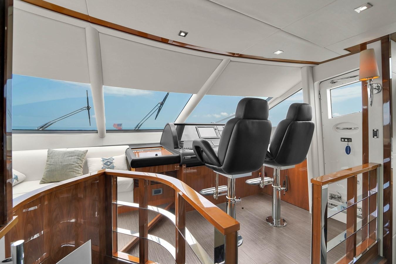 a room with a bed and chairs aboard SUNSEEKER 73 2013 Yacht for Sale