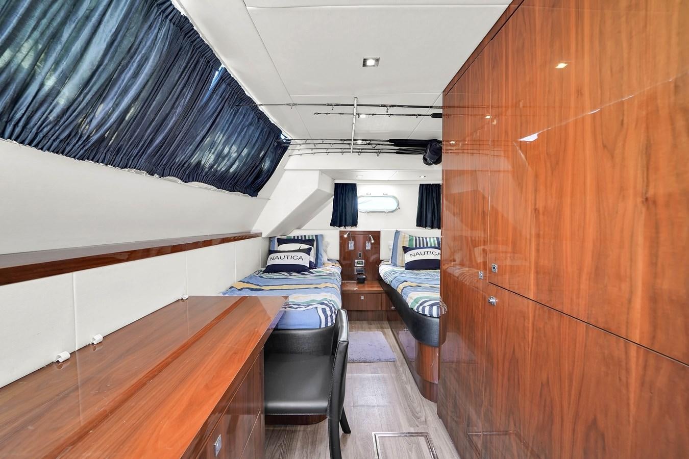 a room with a bed and a desk aboard SUNSEEKER 73 2013 Yacht for Sale