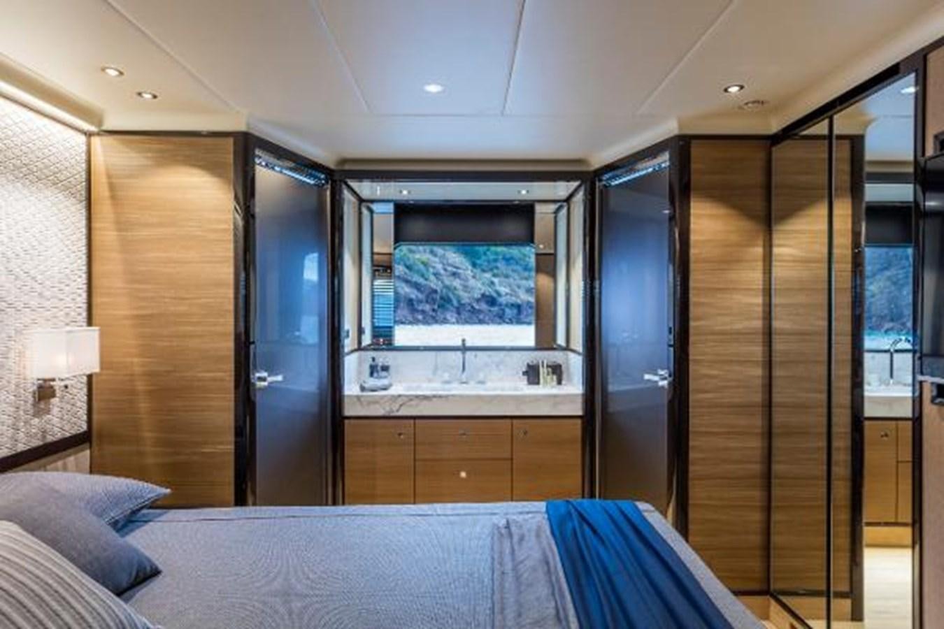a bedroom with a bed and a closet aboard 73 NAVETTA Yacht for Sale