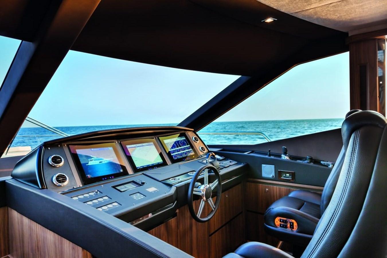a car with a screen on the dashboard aboard 72 FLY Yacht for Sale