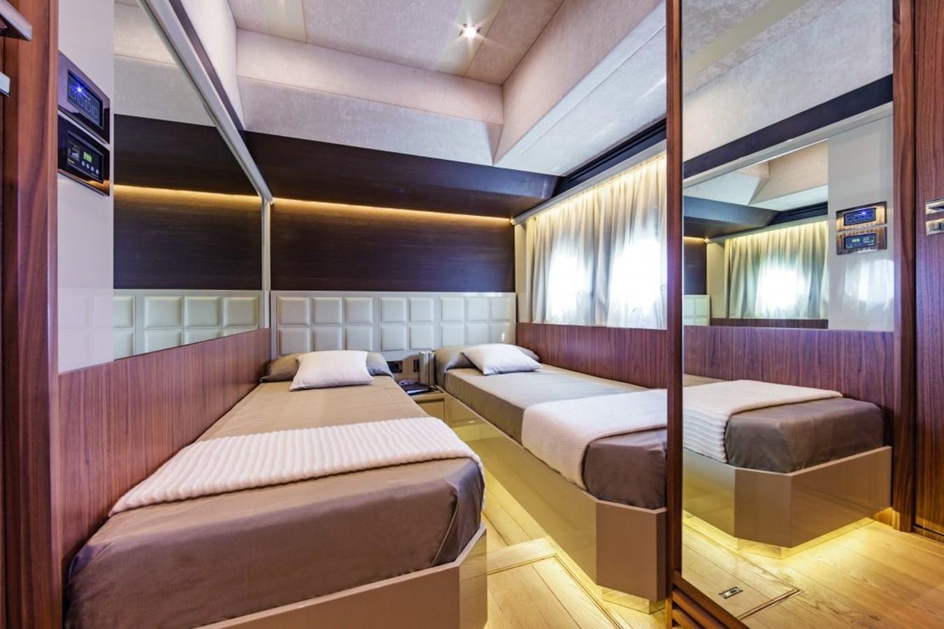 a room with beds and a window aboard 72 FLY Yacht for Sale