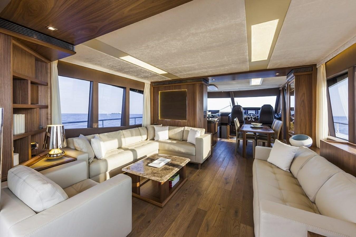 a living room with a large window aboard 72 FLY Yacht for Sale