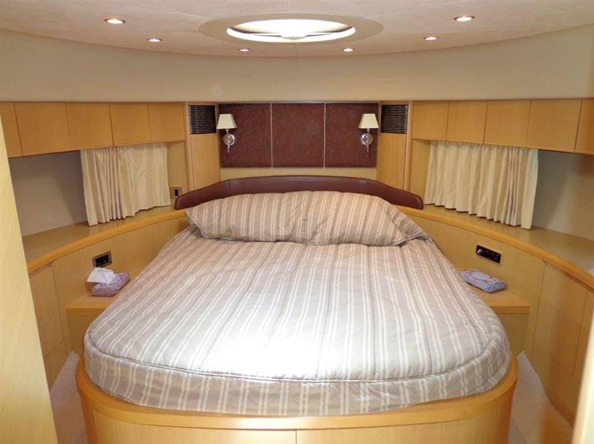 a bed with a white comforter aboard SEA HUSSEIN Yacht for Sale