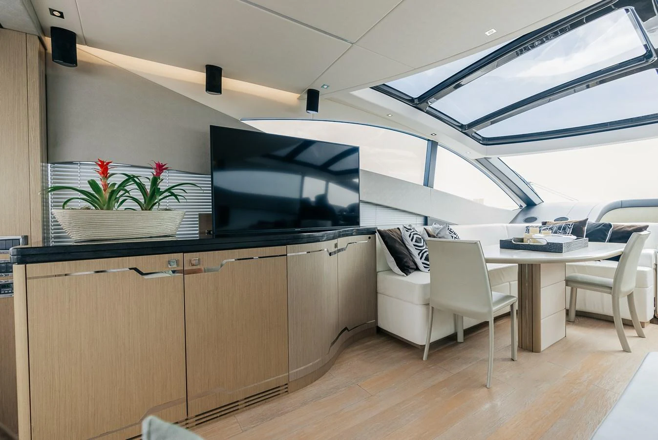 a room with a table and chairs aboard GRAVITAS Yacht for Sale