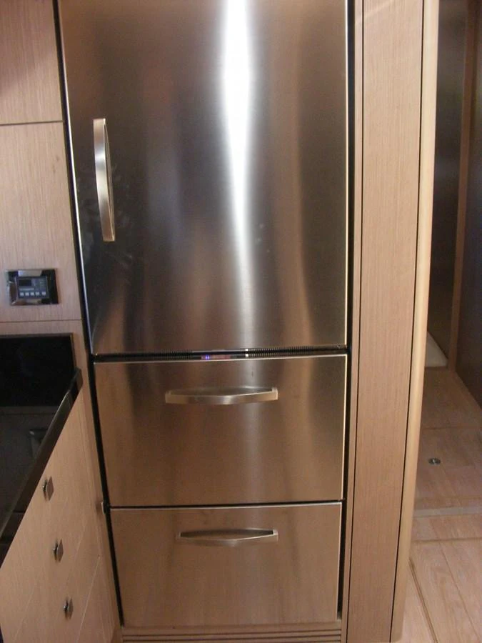 a stainless steel refrigerator in a kitchen aboard GRAVITAS Yacht for Sale
