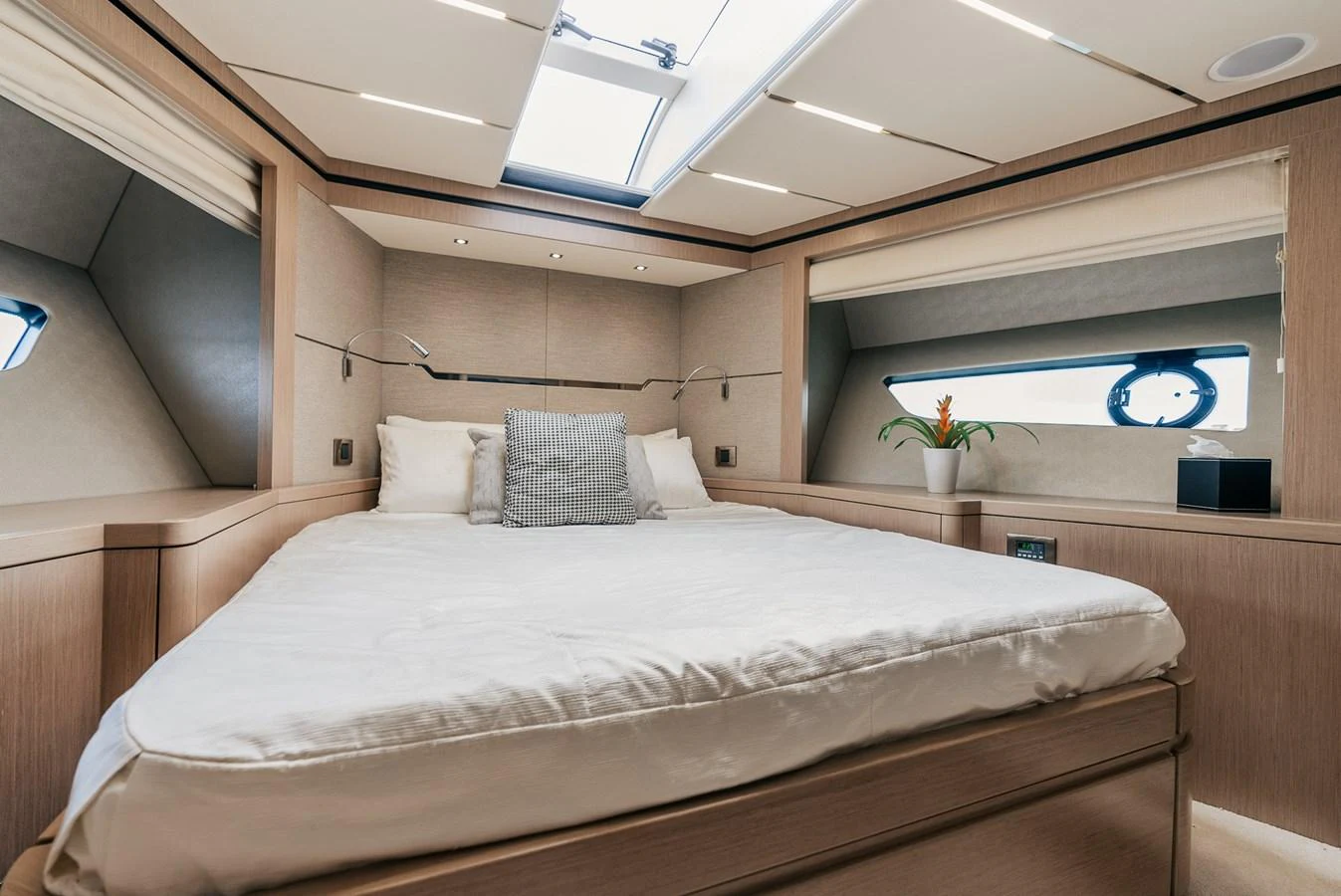 a bed with a white comforter aboard GRAVITAS Yacht for Sale