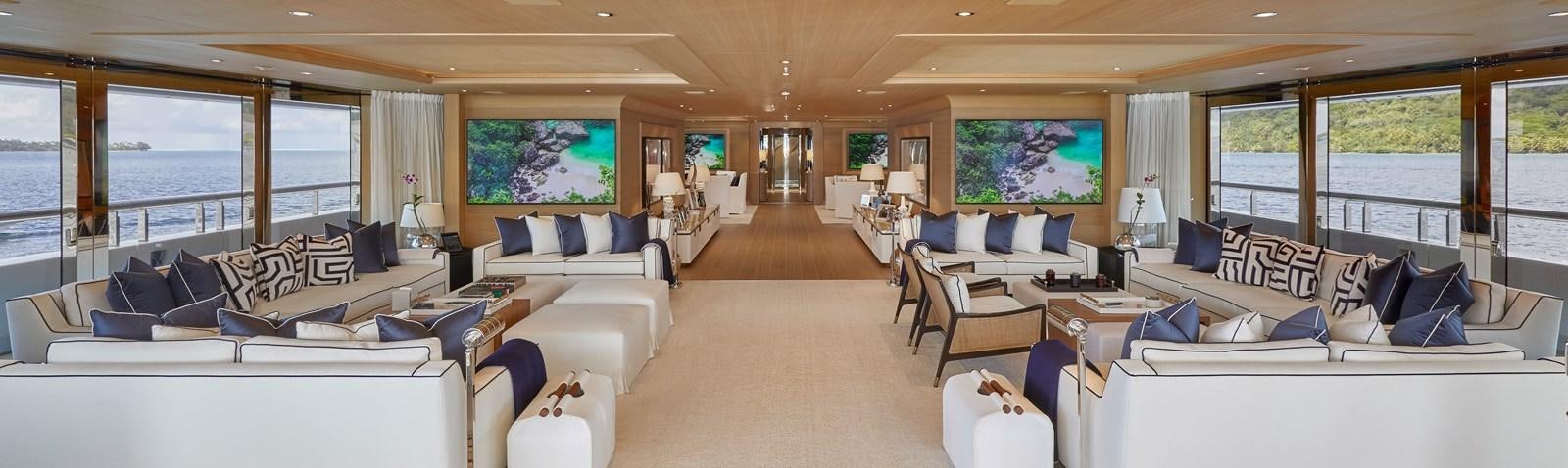 a living room with white furniture aboard IJE Yacht for Sale