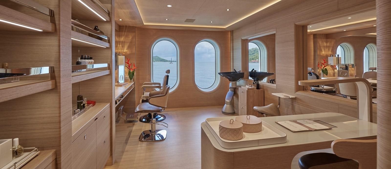 a room with a table and chairs aboard IJE Yacht for Sale