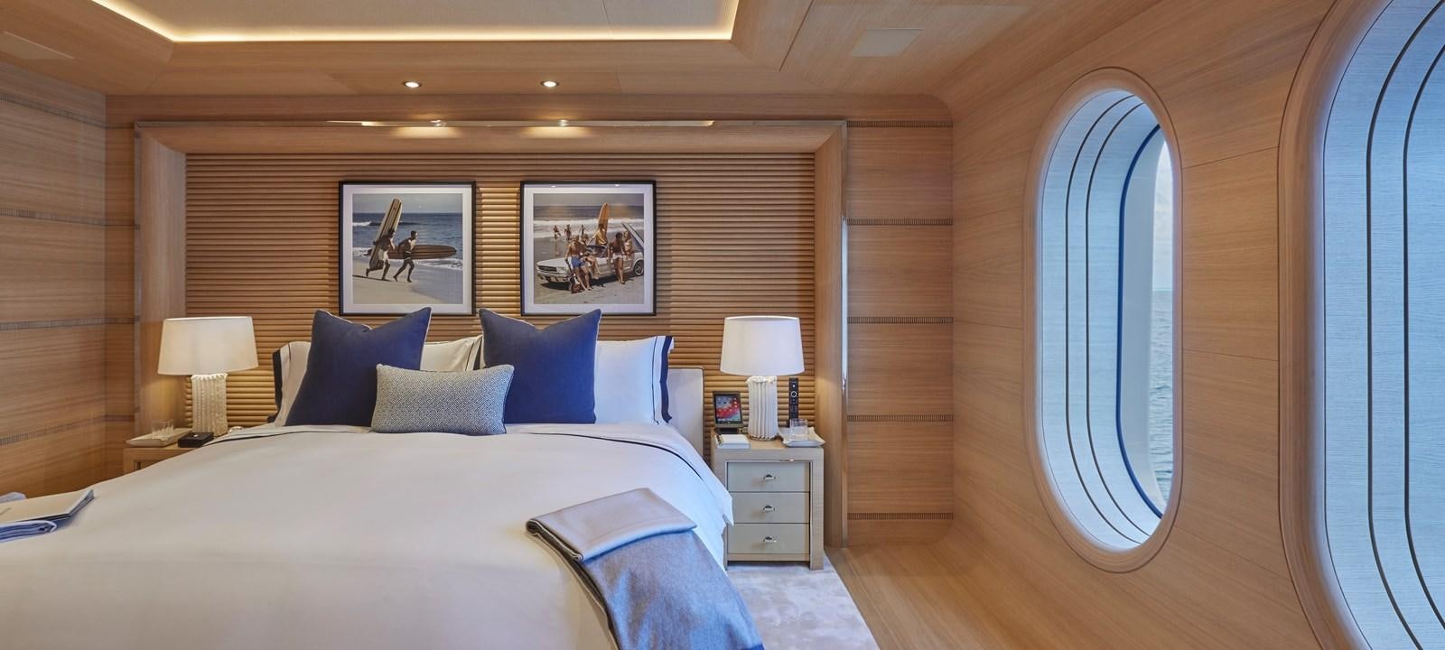 a room with a bed and a window aboard IJE Yacht for Sale