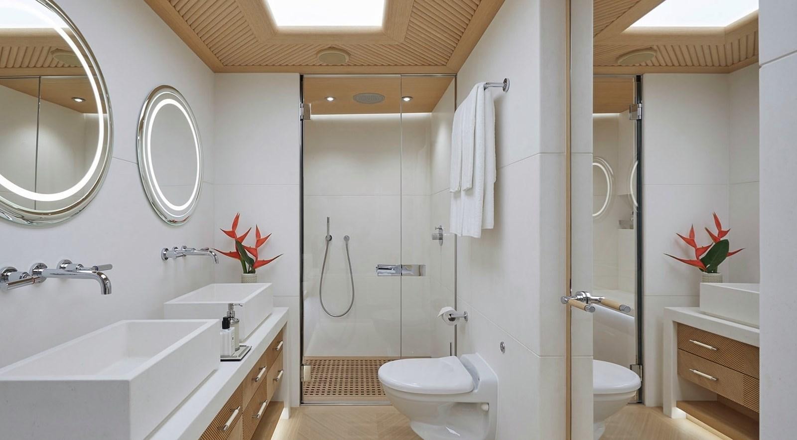 a bathroom with a shower toilet and sink aboard IJE Yacht for Sale