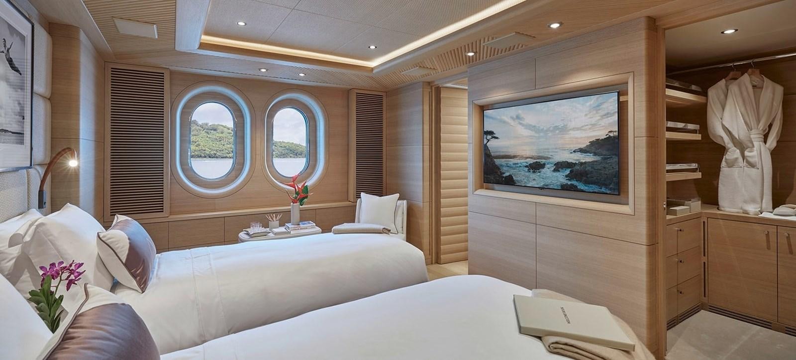 a room with a bed and a mirror aboard IJE Yacht for Sale