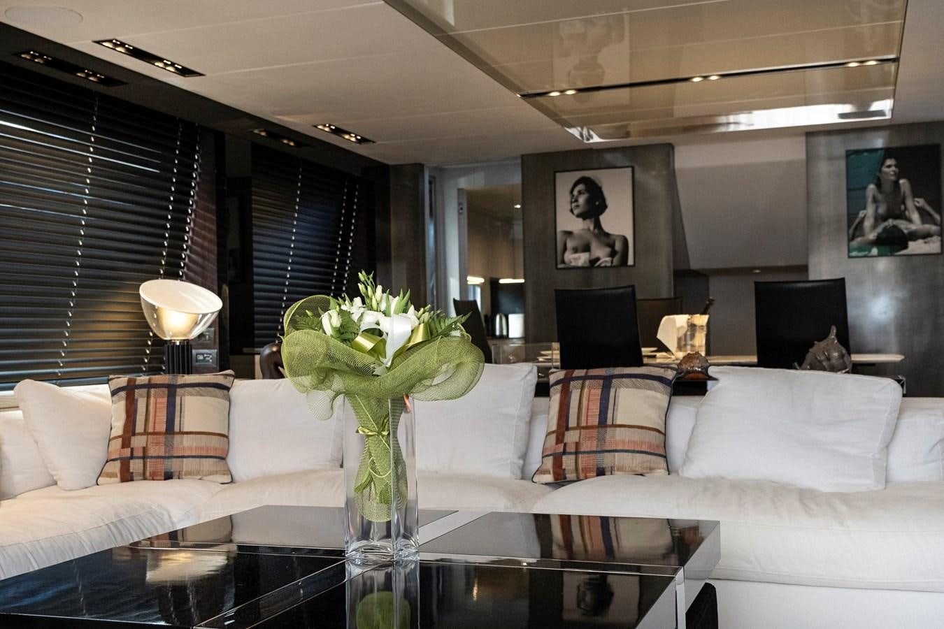 a living room with a glass table aboard ALIX Yacht for Sale