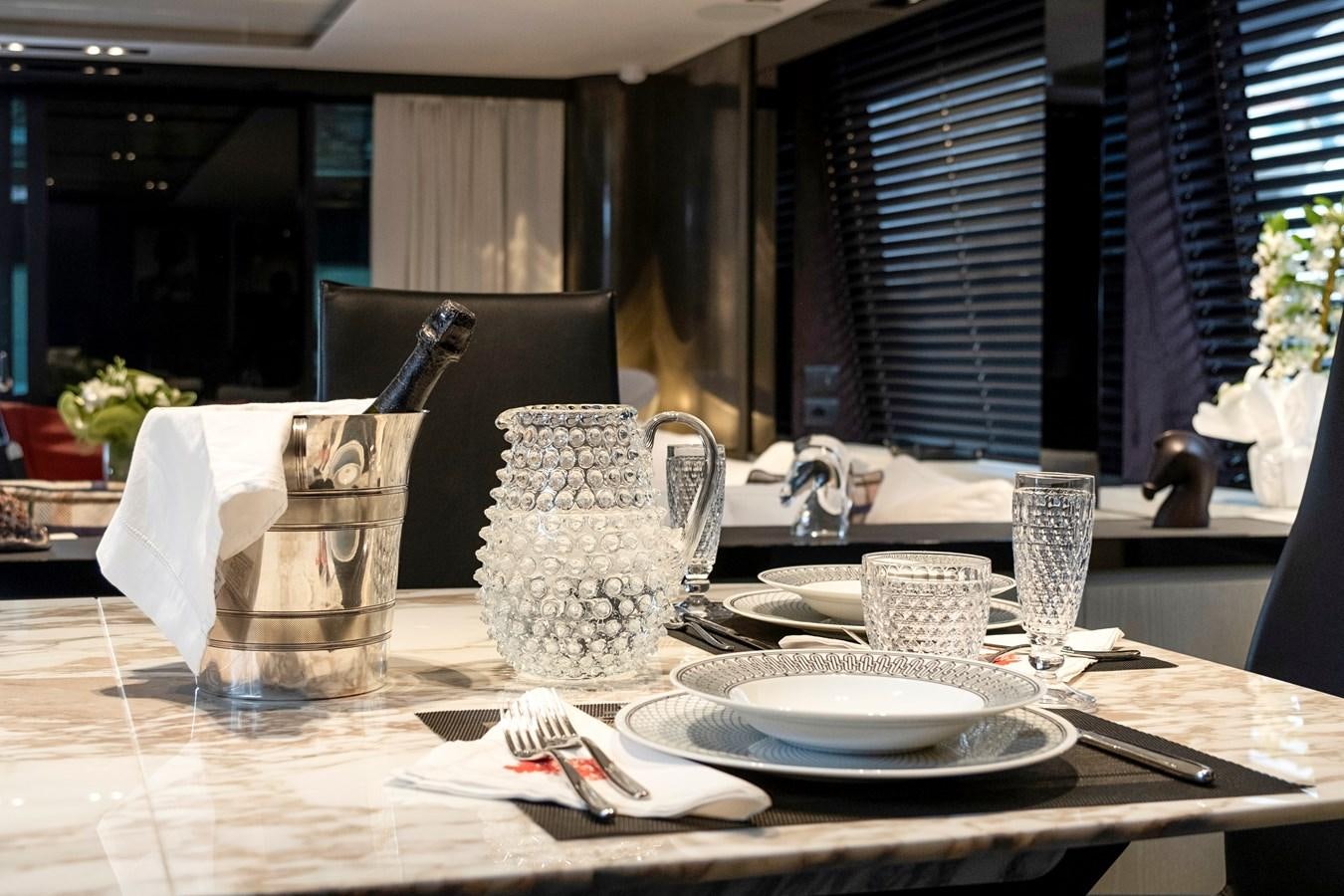 a table with plates and silverware aboard ALIX Yacht for Sale