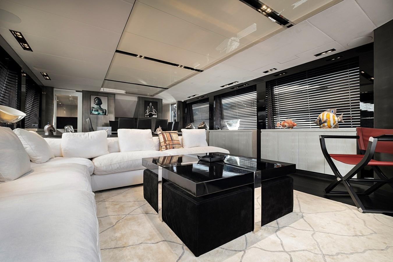 a living room with a white couch and a black table aboard ALIX Yacht for Sale