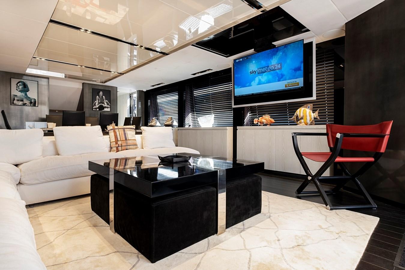 a living room with a tv and couches aboard ALIX Yacht for Sale