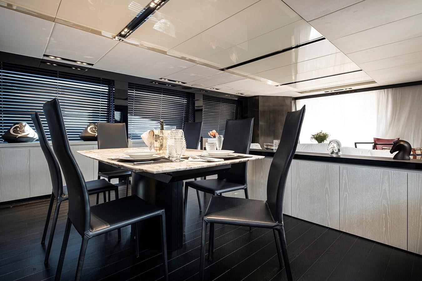 a room with a table chairs and a window aboard ALIX Yacht for Sale
