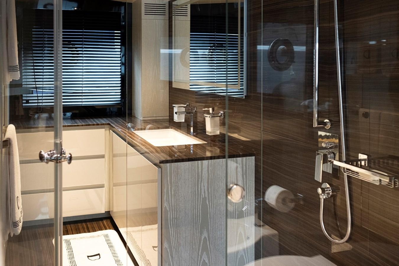 a bathroom with a glass shower aboard ALIX Yacht for Sale
