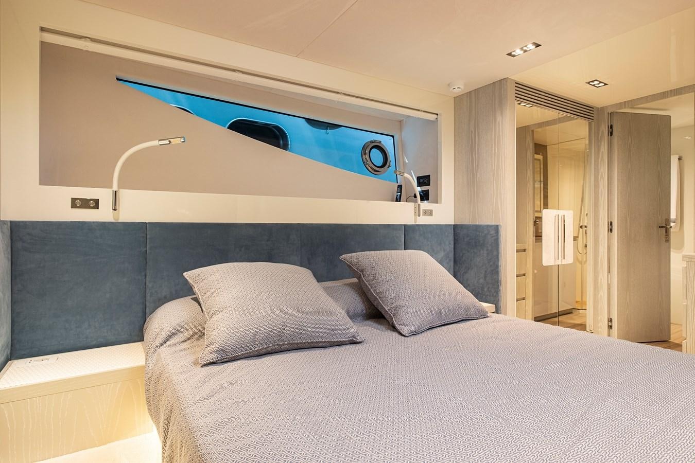 a bed with a blue bed aboard ALIX Yacht for Sale
