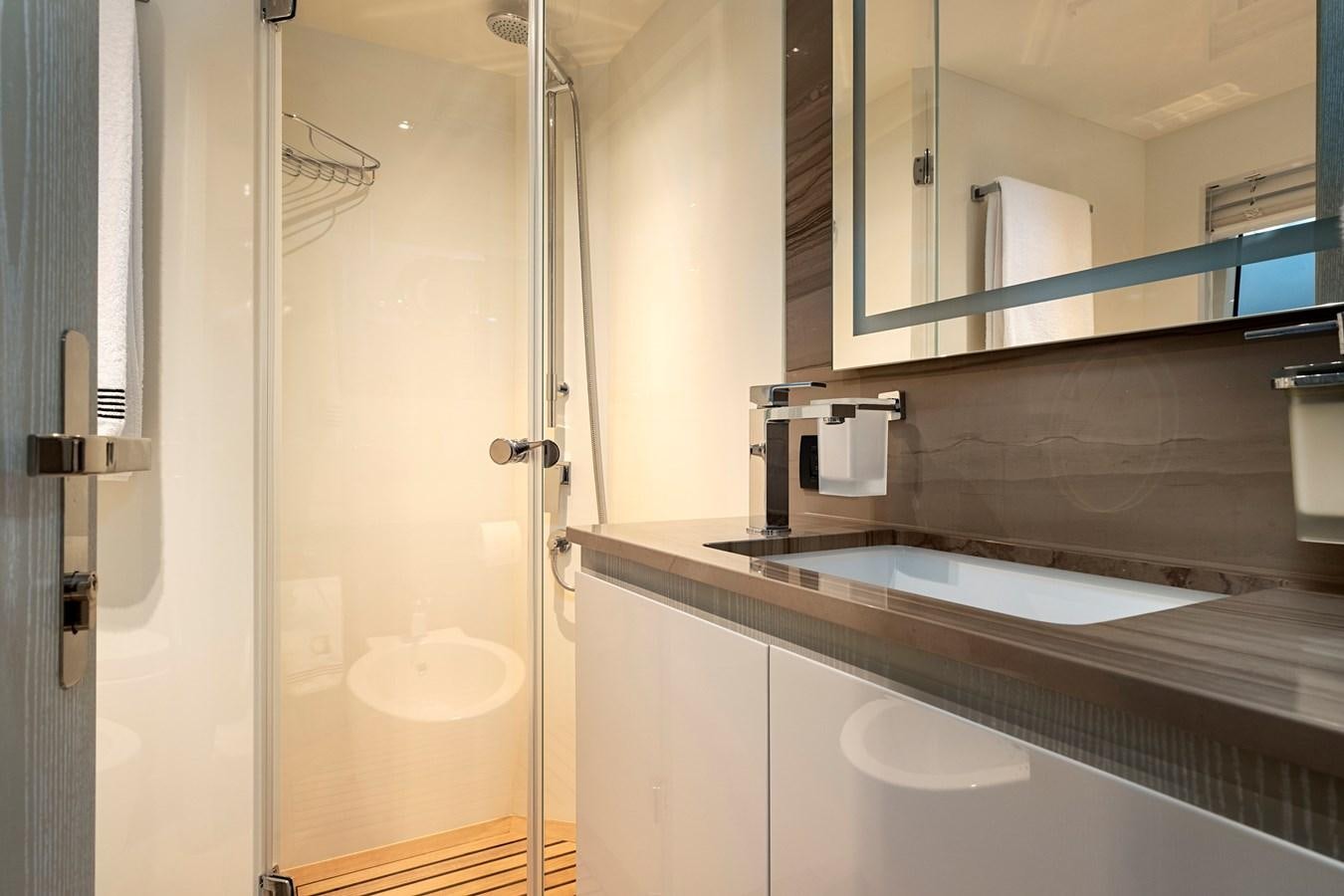 a bathroom with a sink and a mirror aboard ALIX Yacht for Sale