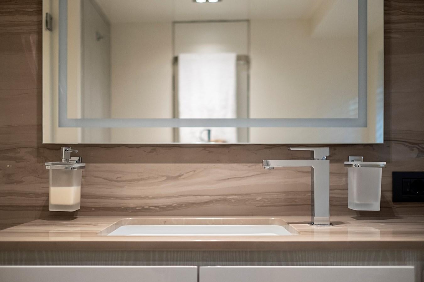 a bathroom with a large mirror aboard ALIX Yacht for Sale