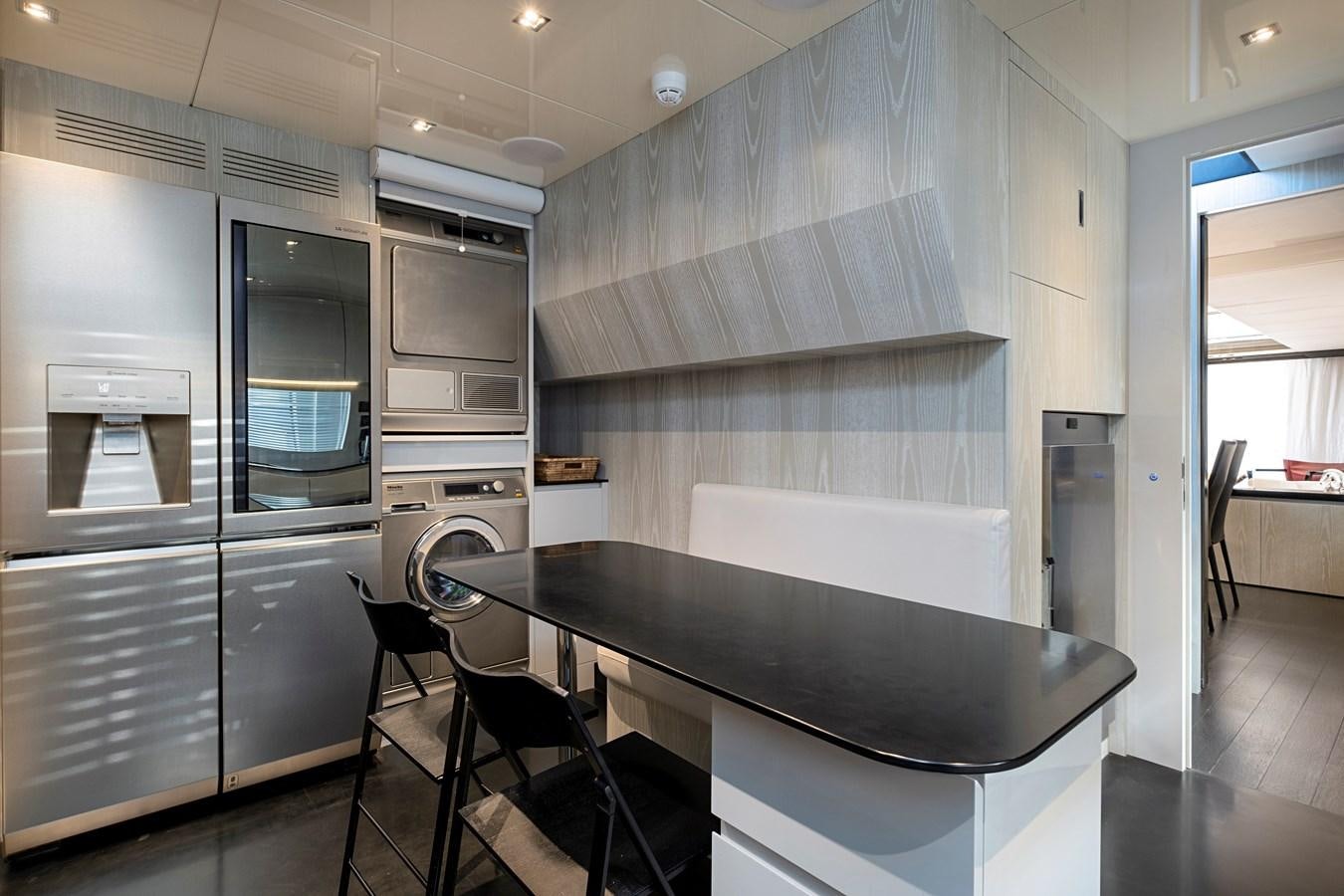 a kitchen with a black table aboard ALIX Yacht for Sale