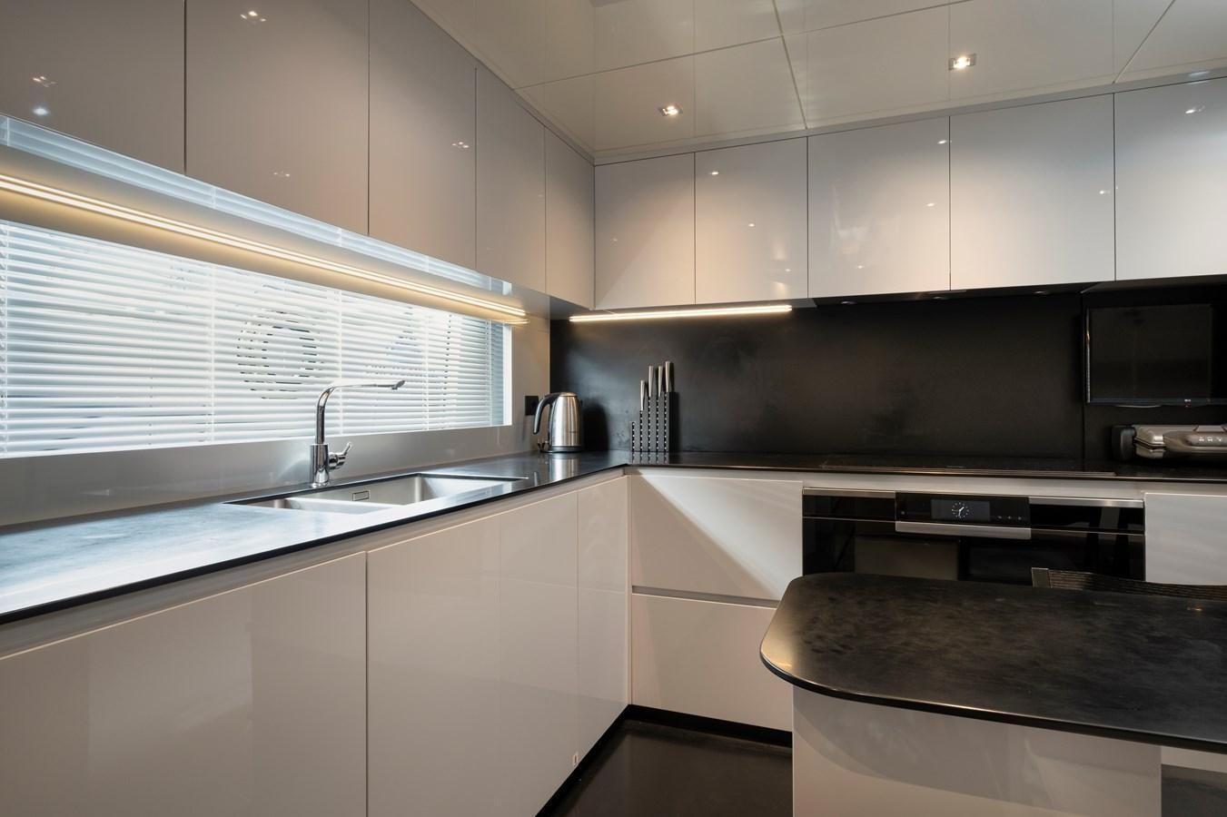 a kitchen with white cabinets aboard ALIX Yacht for Sale