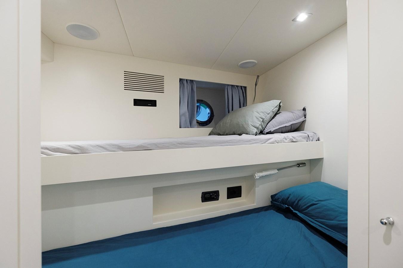 a bed with a blue sheet aboard ALIX Yacht for Sale