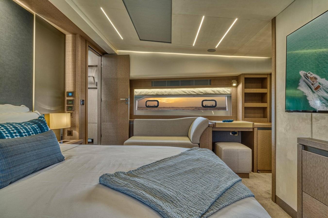 a bedroom with a bed and a desk aboard 690 F LINE  Yacht for Sale