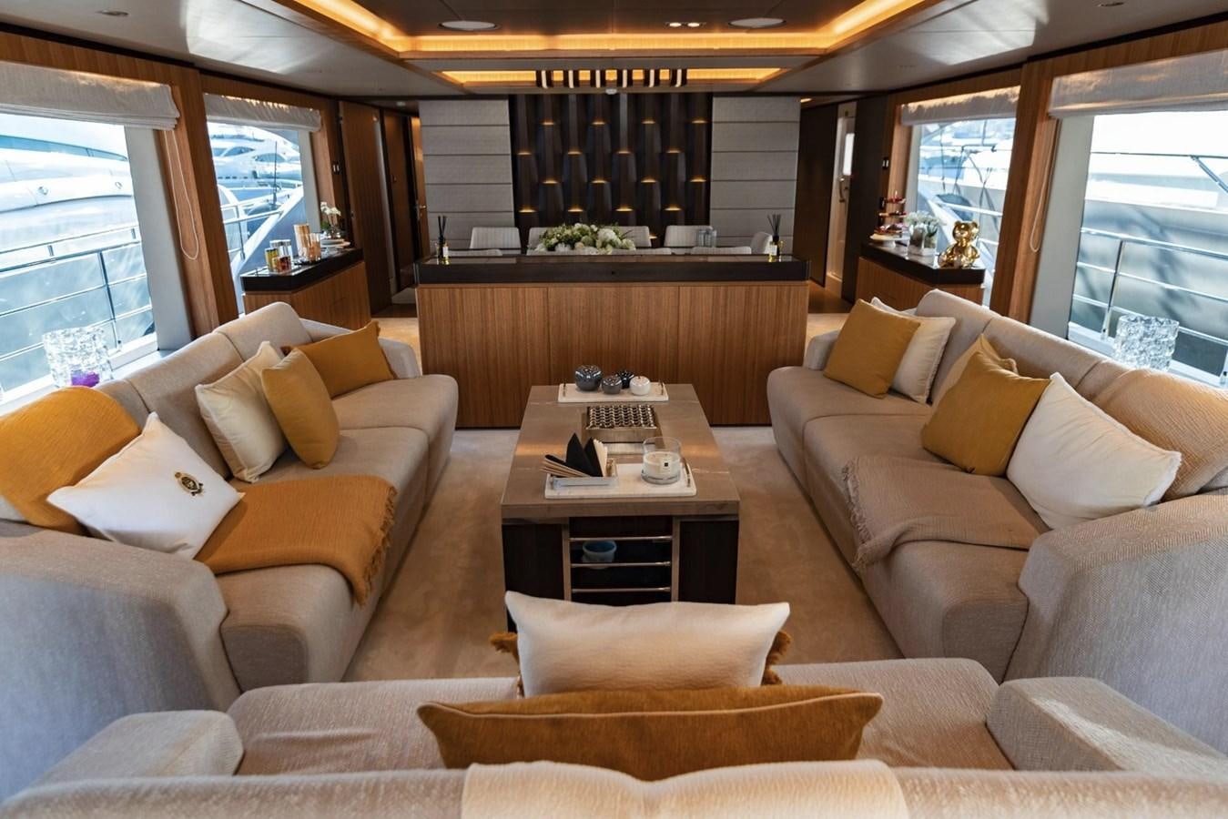 a living room with couches and a coffee table aboard CAROBELLE Yacht for Sale