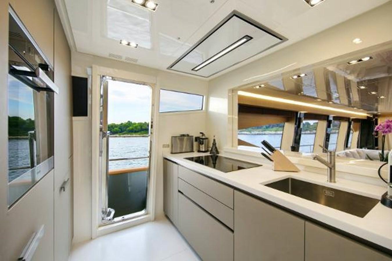 a kitchen with a large window aboard URSUS Yacht for Sale