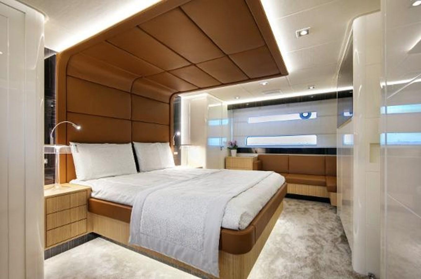 a room with a bed and a desk aboard URSUS Yacht for Sale
