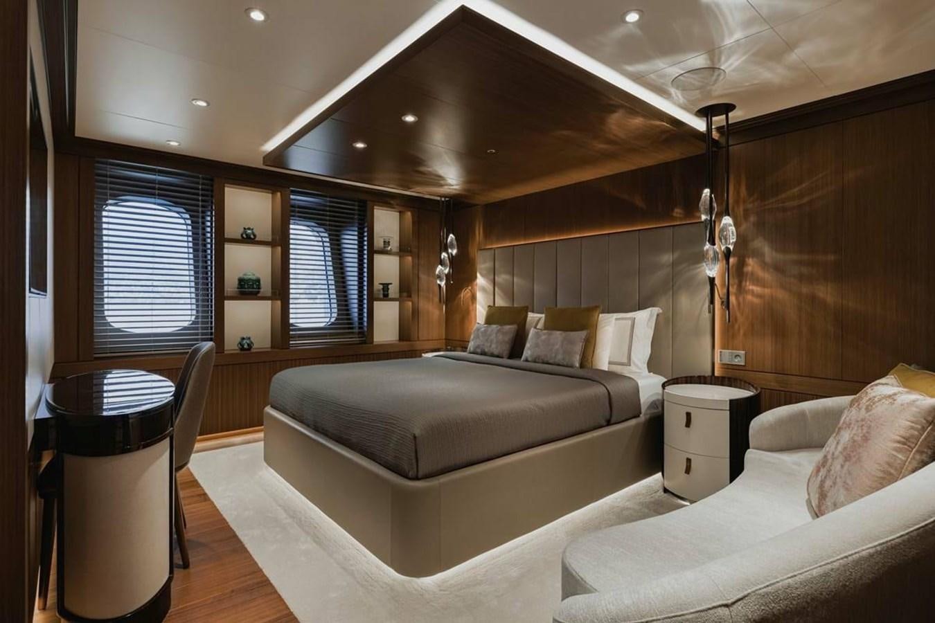 a room with a bed and a chair aboard VICTORIOUS Yacht for Sale