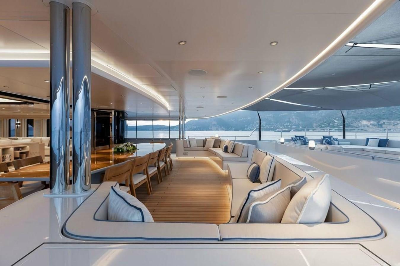 a large room with a large lounge chair and a large window aboard VICTORIOUS Yacht for Sale