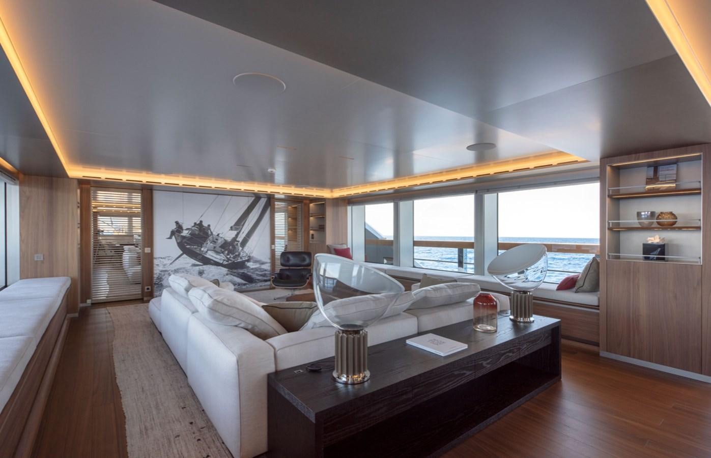 a living room with a large window aboard MYKO Yacht for Sale