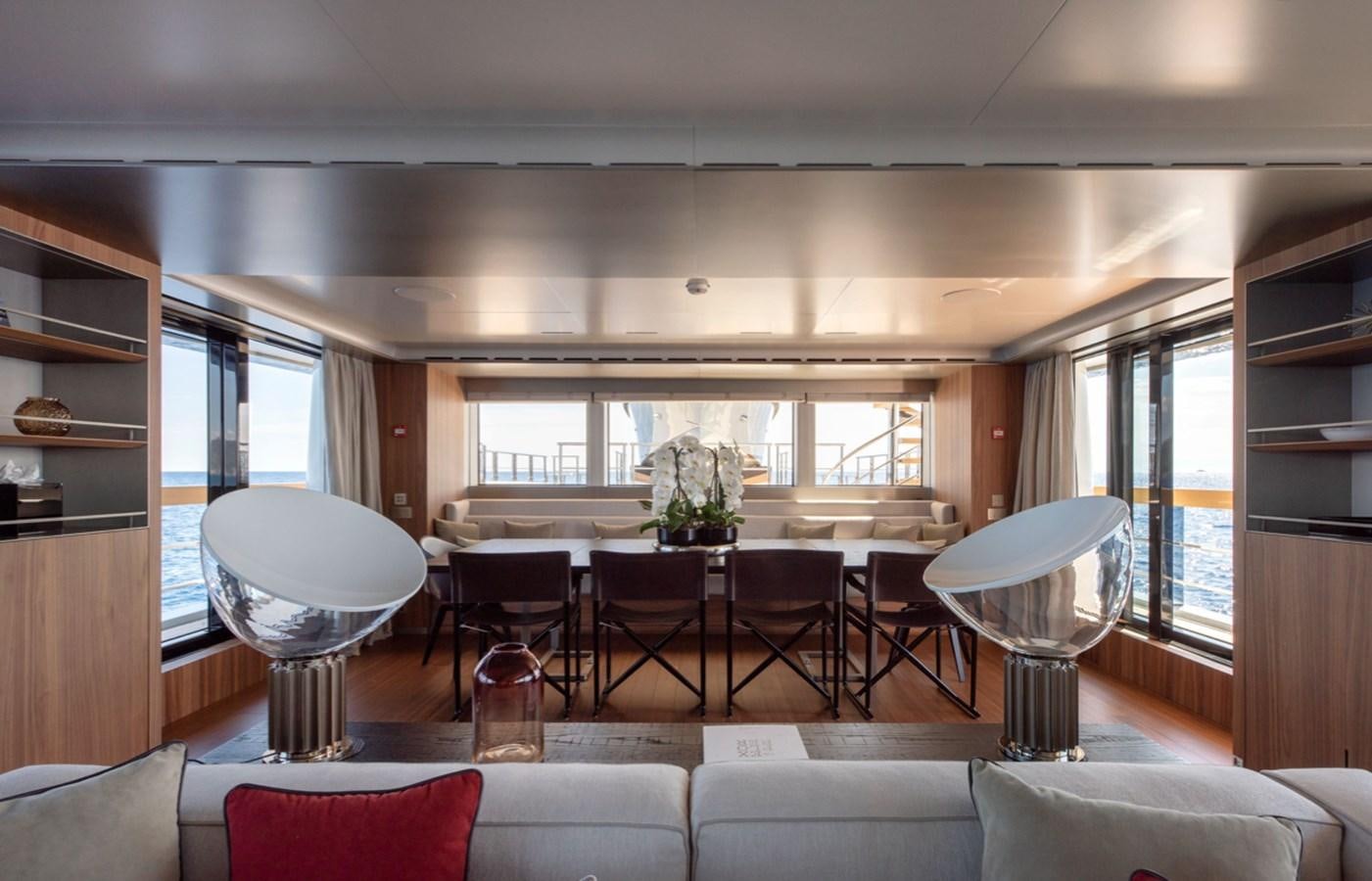 a living room with a large table and chairs aboard MYKO Yacht for Sale
