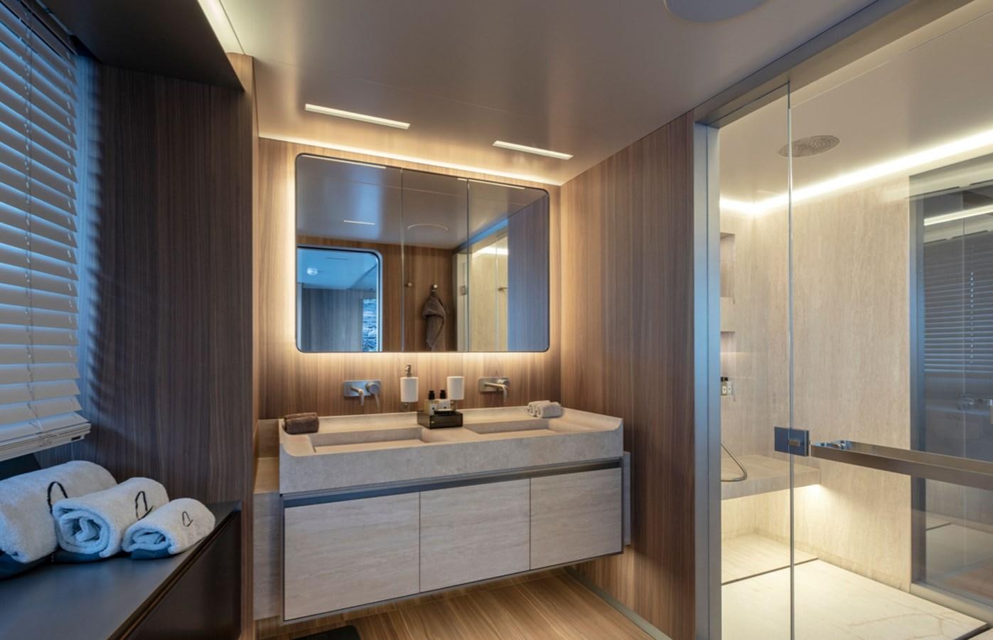 a bathroom with a glass shower aboard MYKO Yacht for Sale