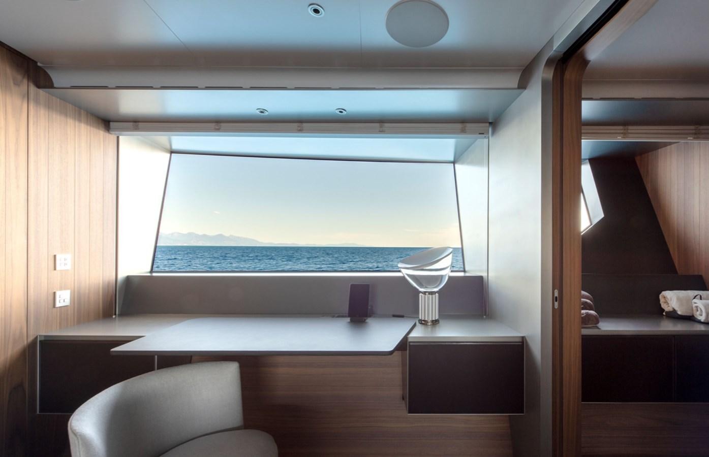 a room with a table and chairs aboard MYKO Yacht for Sale