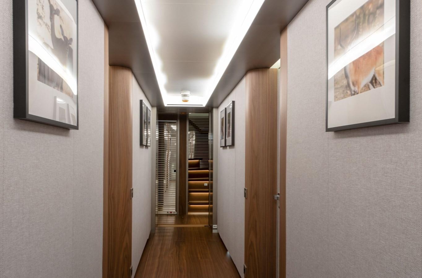 a hallway with a wood floor and a wood door aboard MYKO Yacht for Sale