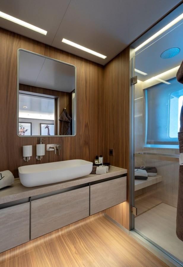 a bathroom with a large mirror aboard MYKO Yacht for Sale