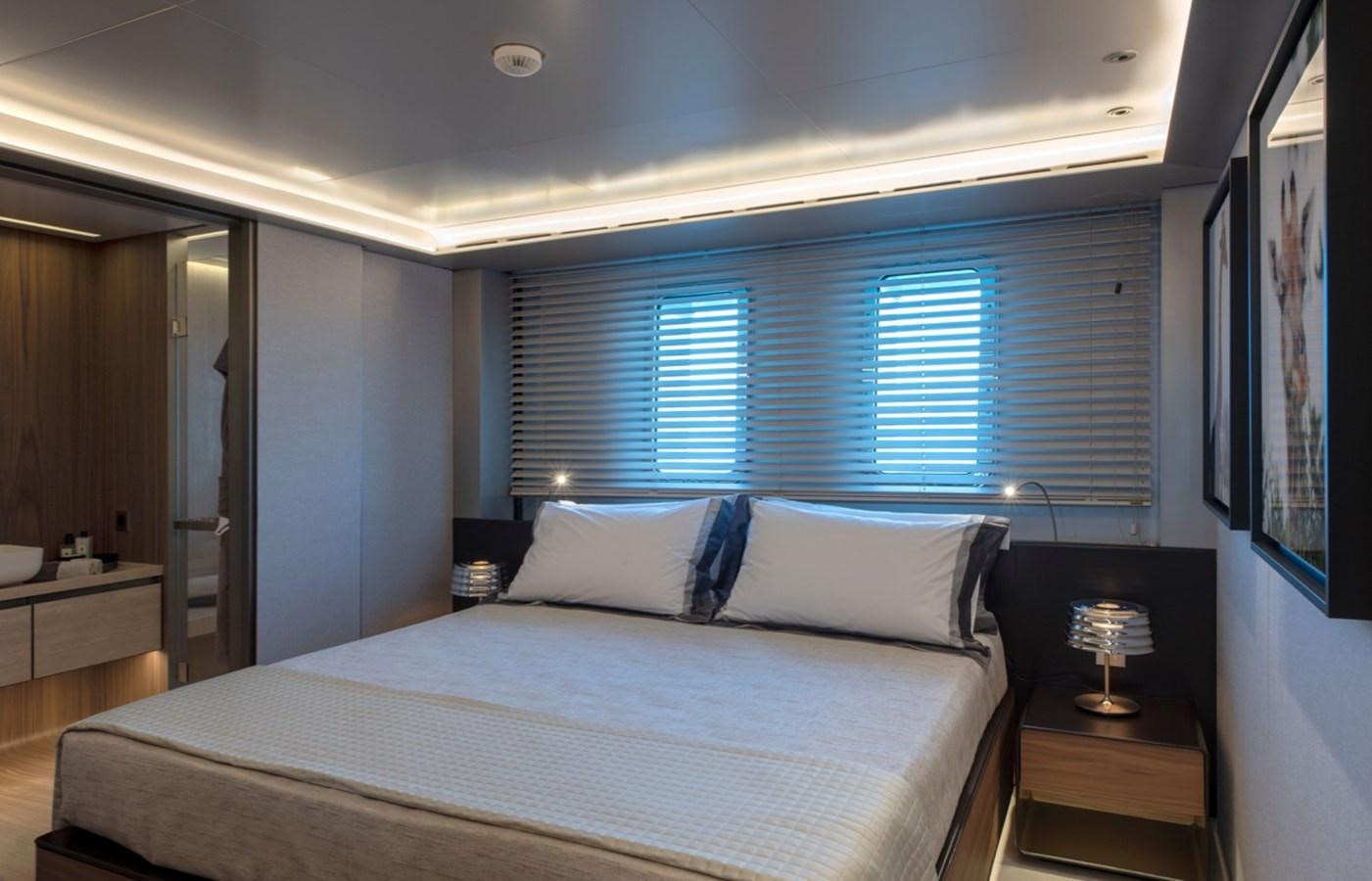 a bed with a white bed spread aboard MYKO Yacht for Sale