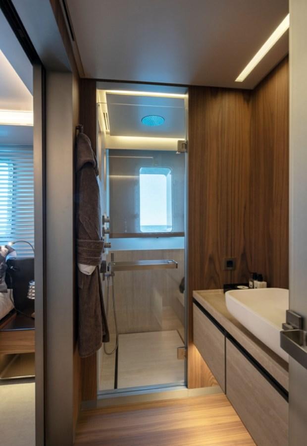 a bathroom with a glass shower aboard MYKO Yacht for Sale