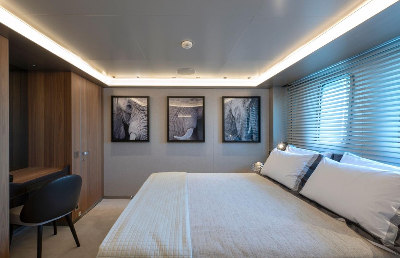 a bedroom with a bed and a window aboard MYKO Yacht for Sale